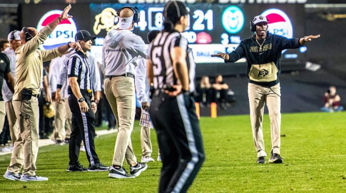 Colorado’s Deion Sanders communicates to his players from the sidelines.